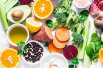 A surface full of raw vegetables and fruit