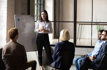 A woman presenting to colleagues