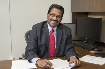 Dominic Raj, MD, in his office