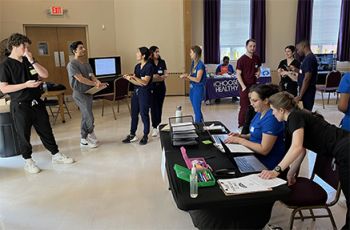 Teledermatology members prepare to see patients at clinic