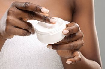 Woman preparing to apply lotion to her skin