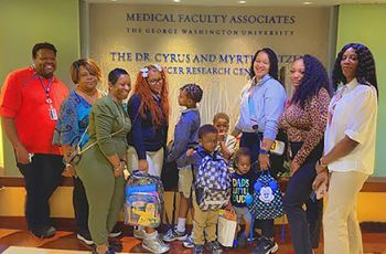 GW Cancer Center staff deliver backpacks for patients' kids 