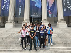 Upward Bound Program students standing on the steps of a museum