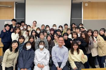 Roger Ideishi in Tokyo with group of students smiling