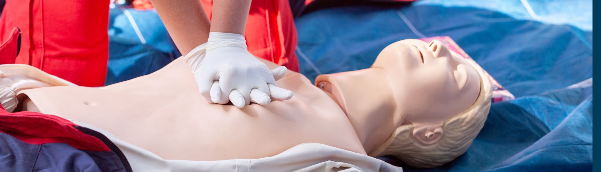 Someone practicing CPR on a training dummy