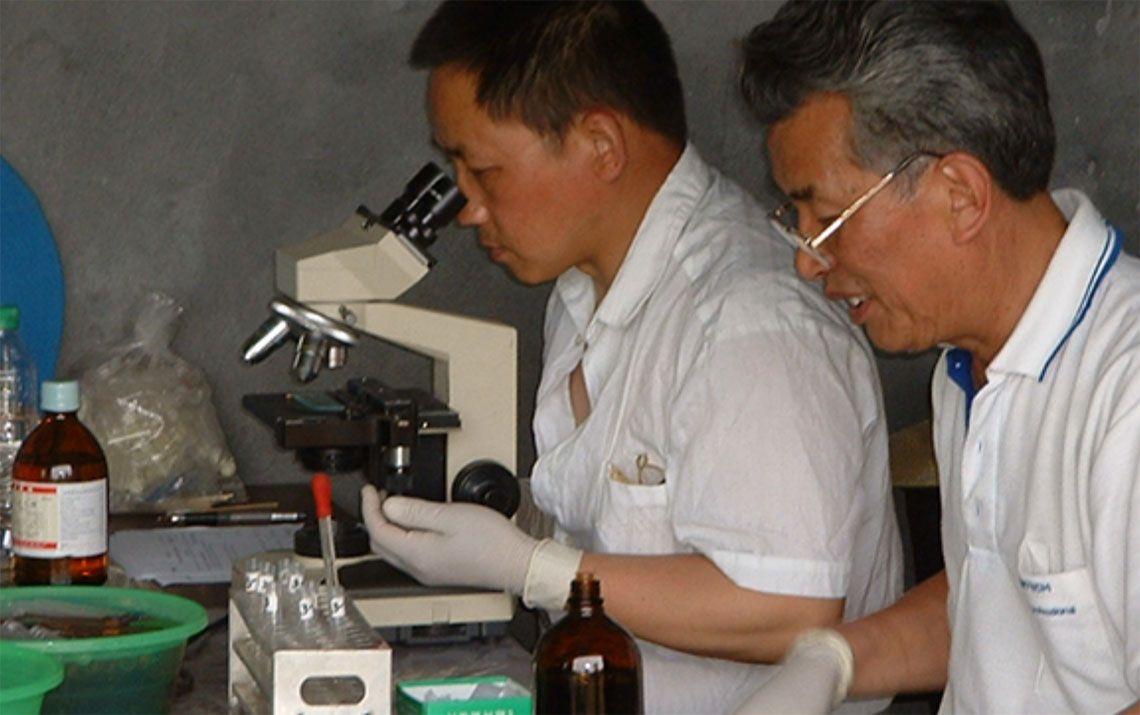 Researchers using lab equipment 