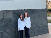 Two doctors standing in front of School of Medicine